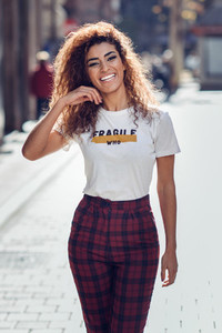 Smiling arab girl in casual clothes in the street