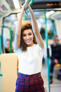 Smiling arab woman inside subway train