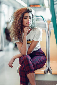 Arab woman inside metro train  Arab girl in casual clothes