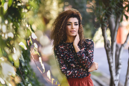 Beautiful young arabic woman with black curly hairstyle