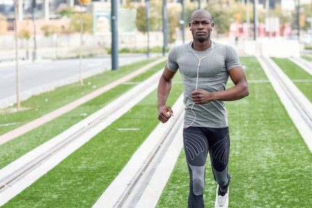 Attractive black man running in urban background