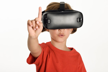 Little girl looking in VR glasses and gesturing with his hands