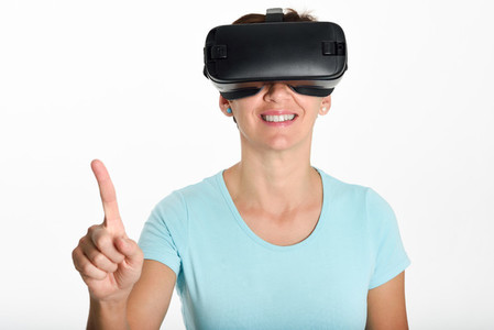Woman looking in VR glasses and gesturing with his hands