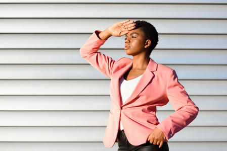 Black woman model of fashion standing on urban wall