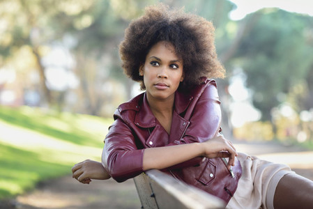 Young black woman with afro hairstyle standing in urban backgrou