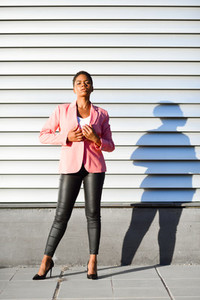 Black woman  model of fashion  standing on urban wall