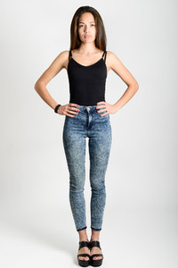 Young woman wearing black tank top and blue jeans