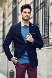 Attractive man wearing british elegant suit in the street Modern hairstyle