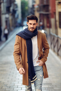 Young man wearing winter clothes in the street