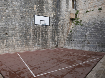 Basketball court and hoop in stone courtyard
