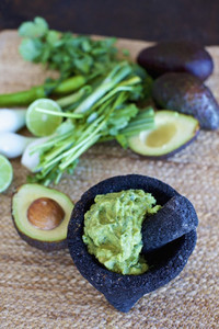 Close up homemade  fresh guacamole in mortar