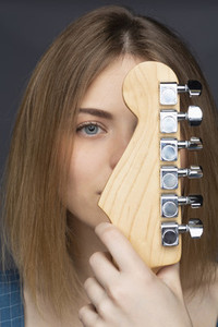 Close up portrait beautiful young woman with guitar