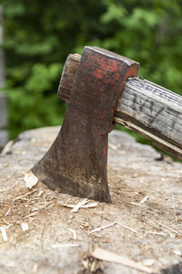 Close up wood chopping axe in tree stump