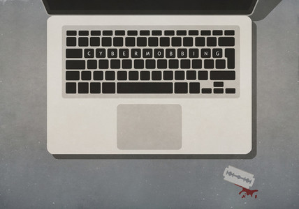 Cyber Mobbing text on laptop keyboard next to razor blade with blood