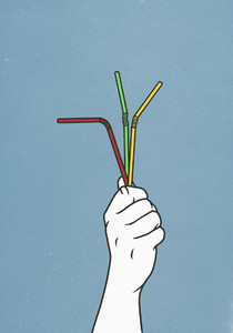Hand holding three straws