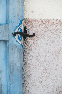 Iron latch on blue wooden door