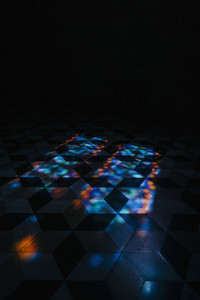 Kaleidoscope reflection of lights on tile floor