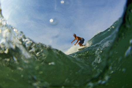Male surfer riding ocean wave 01