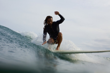 Male surfer riding ocean wave 08