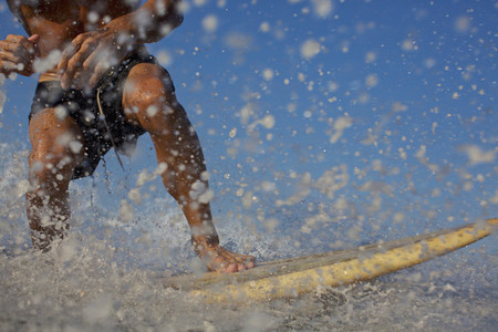 Male surfer riding ocean wave  splashing