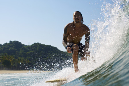Male surfer riding sunny ocean wave 04