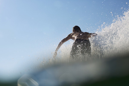 Male surfer riding wave