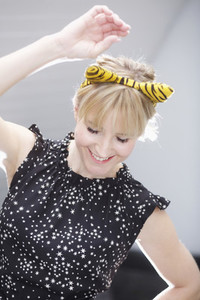Playful woman in cat costume ears dancing