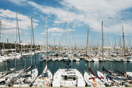 Sailboats moored in sunny Olympic Harbor  Barcelona  Spain