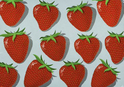 Vibrant red strawberries on gray background