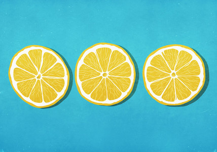 Vibrant yellow lemon slices against blue background
