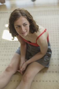 Woman relaxing sitting on rug