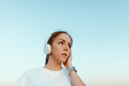 Young woman with her headphones listened external communications