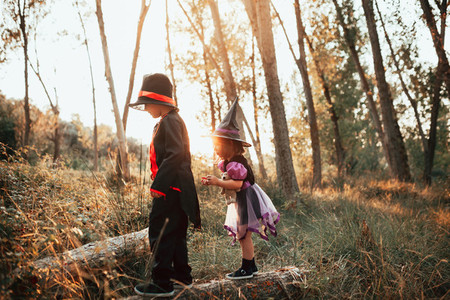 Two children disguised for Halloween in the woods