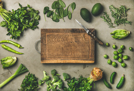 Healthy vegan ingredients and wooden board in center