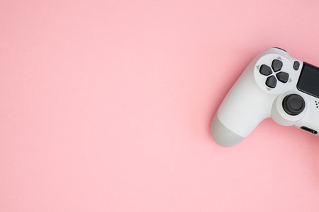 Video games white gaming controller isolated on pink color backg