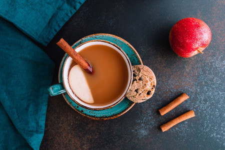 Wintertime chai spiced apple cider with assam tea  cinnamon  ginger  cardamom and almond milk  Christmas or Thanksgiving cozy flat lay