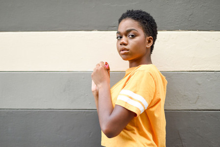 Young black woman with serious expression looking at camera