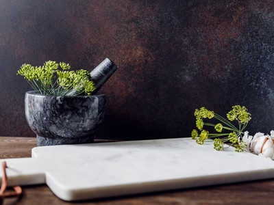 Kitchen table with white marble tray mortar and herbs Background for text
