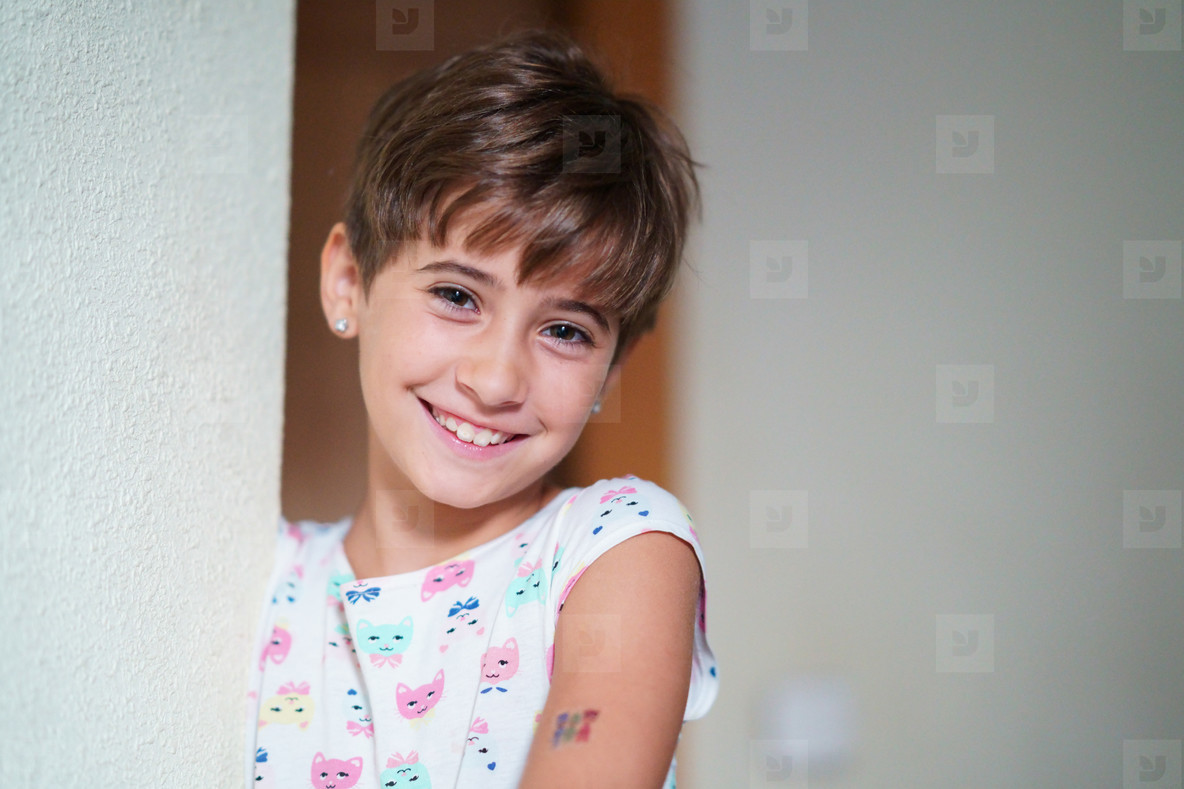 Adorable little girl, eight years old, staring smiling to camera.