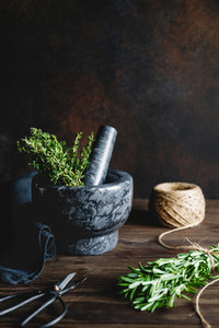 Fresh herbs in a marble mortar on a table  Rustic style food photography