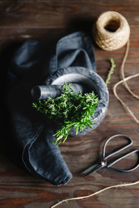 Fresh herbs in a marble mortar on a table Rustic style food photography top view