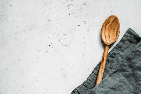 Wooden spoon and grey linen napkin