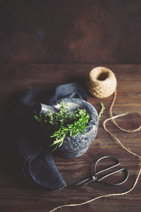 Fresh herbs in a marble mortar on a table  Rustic style food photography  top view