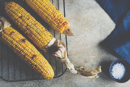 Roasted or grill corn cob with olive oil and salt on a rack  Tasty simple recipe  top view