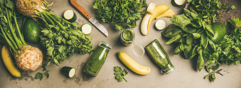 Ingredients for making green smoothie over concrete background