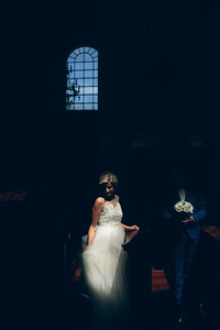 bride and groom illuminated by light