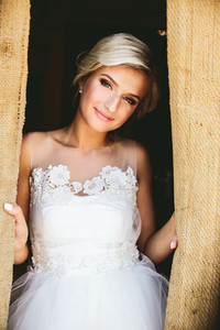 Smiling beautiful bride in doorway