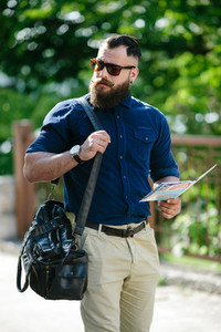 bearded man with a map in hand