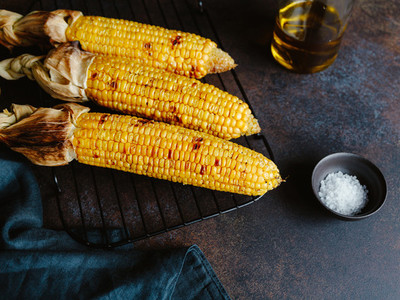 Roasted or grill corn cob with olive oil and salt on a rack  Tasty simple recipe  top view