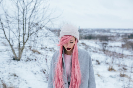 girl with pink hair posing at the camera